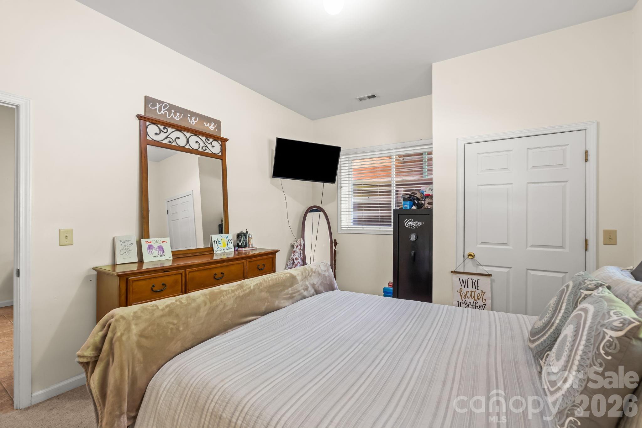 3341 Peniel Road Tryon, NC 28782 - Photo 39 of 48 a bedroom with a bed and a flat screen tv
