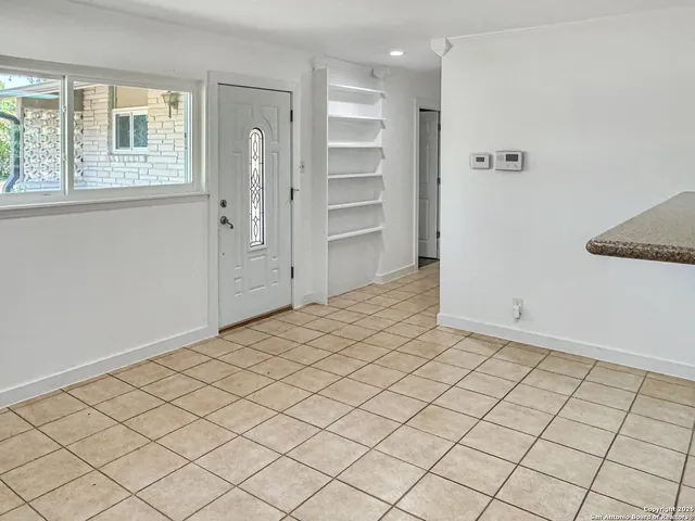 a kitchen with granite countertop a refrigerator and a stove top oven