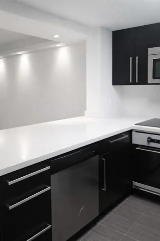 a kitchen with a sink and cabinets