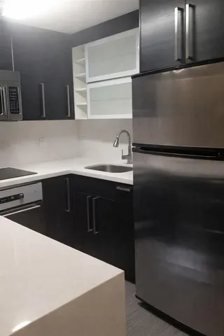 a kitchen with a refrigerator and a sink