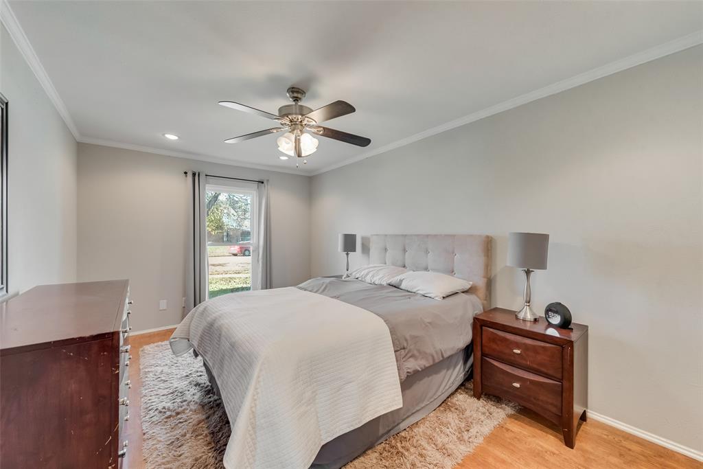 1954 Rambling Ridge Lane Carrollton, TX 75007 - Photo 16 of 23 a bedroom with a bed and a chandelier