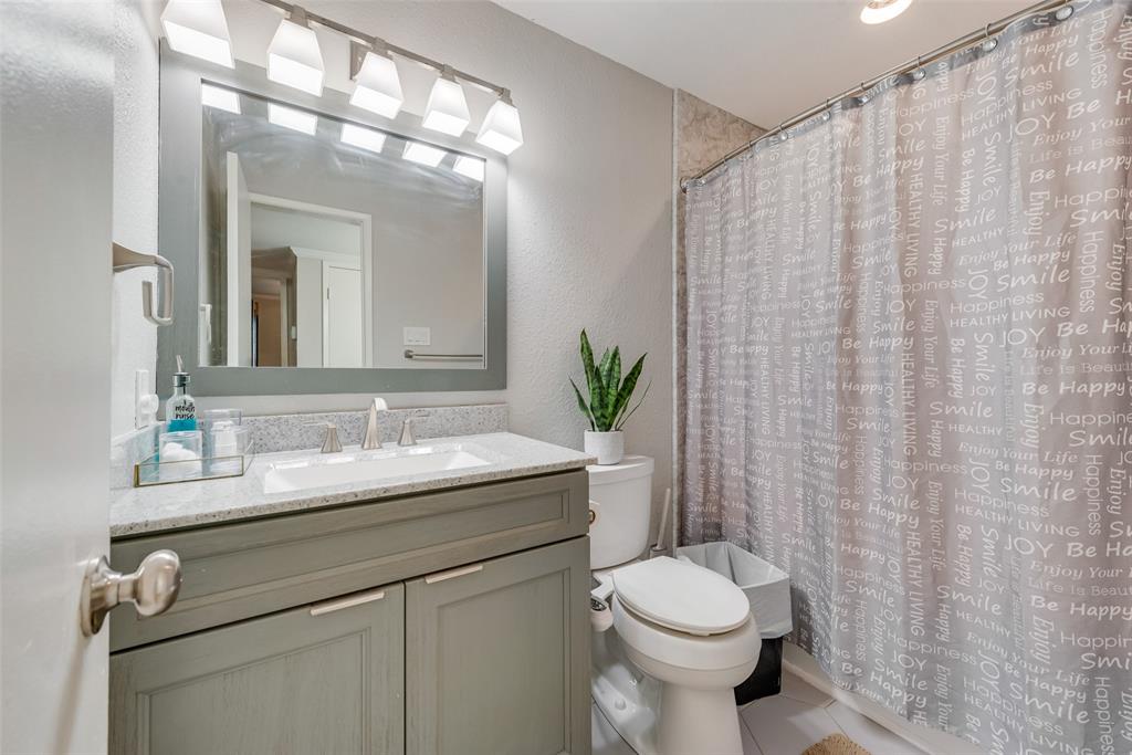 1954 Rambling Ridge Lane Carrollton, TX 75007 - Photo 17 of 23 a bathroom with a toilet sink and mirror