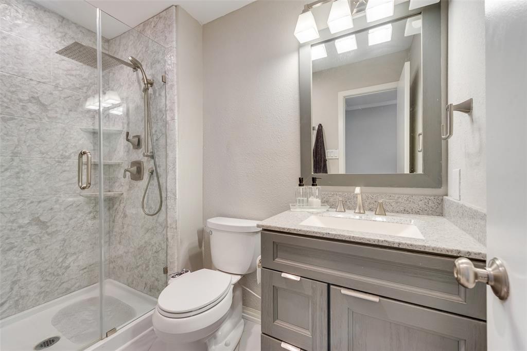 1954 Rambling Ridge Lane Carrollton, TX 75007 - Photo 21 of 23 a bathroom with a sink toilet vanity and shower