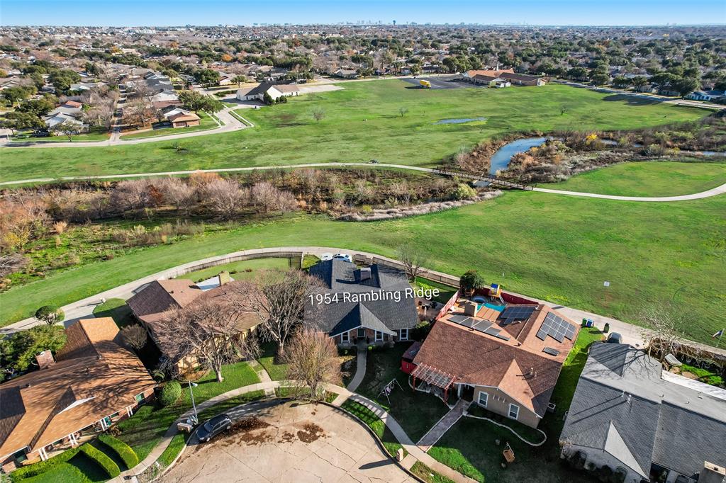 1954 Rambling Ridge Lane Carrollton, TX 75007 - Photo 3 of 23 an aerial view of a house with a garden and lake view