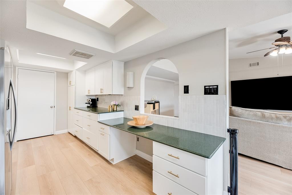 1954 Rambling Ridge Lane Carrollton, TX 75007 - Photo 5 of 23 a kitchen with granite countertop a sink and a stove top oven