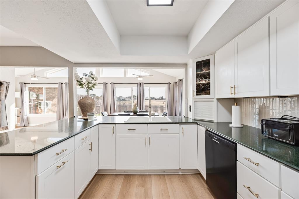 1954 Rambling Ridge Lane Carrollton, TX 75007 - Photo 7 of 23 a kitchen with granite countertop white cabinets and white appliances