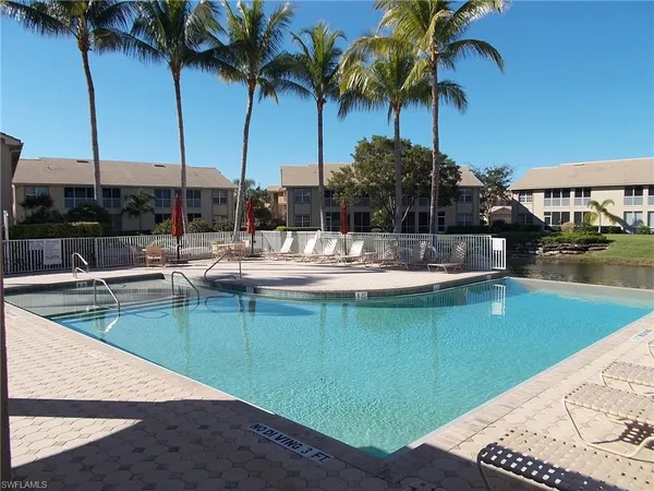 a view of a swimming pool with a table and chairs
