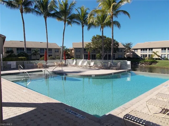 a view of a swimming pool with a table and chairs