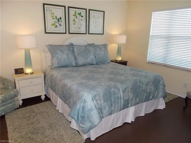 a bedroom with a bed and a night stand