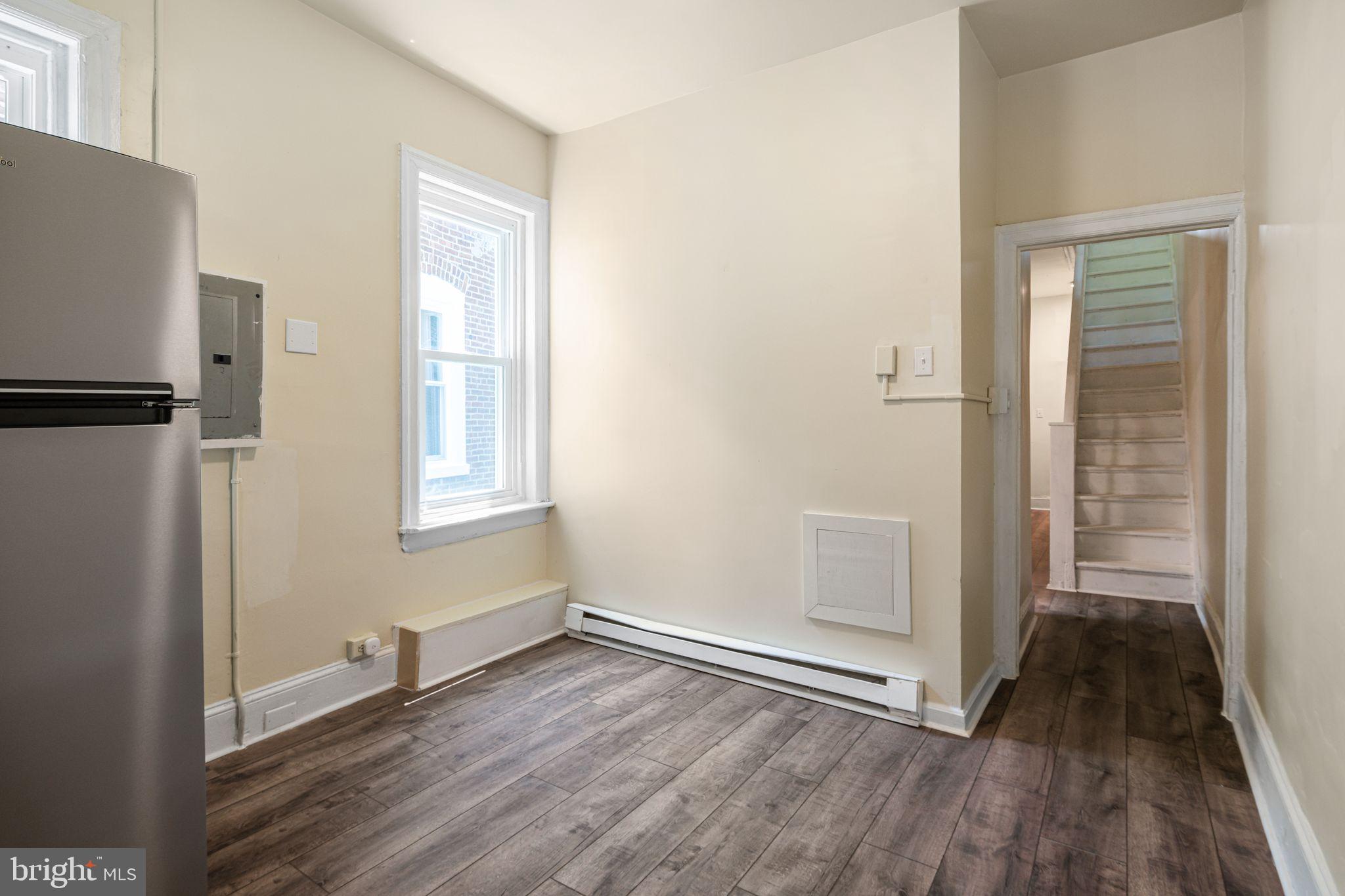 7153 Germantown Avenue, Unit 4 Philadelphia, PA 19119 - Photo 4 of 11 an empty room with wooden floor and a window