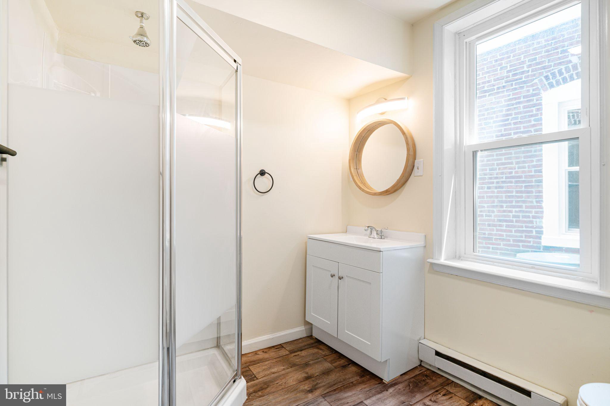 7153 Germantown Avenue, Unit 4 Philadelphia, PA 19119 - Photo 6 of 11 a bathroom with a sink a toilet and a window