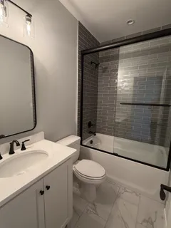 a bathroom with a sink toilet and shower