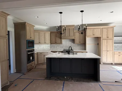 a kitchen with kitchen island stainless steel appliances a sink stove and refrigerator