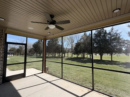 a view of a room with porch and a ceiling fan