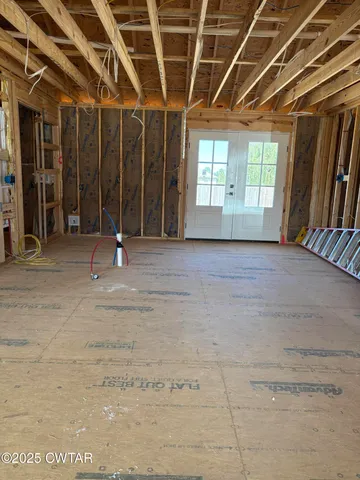 a view of an empty room with windows