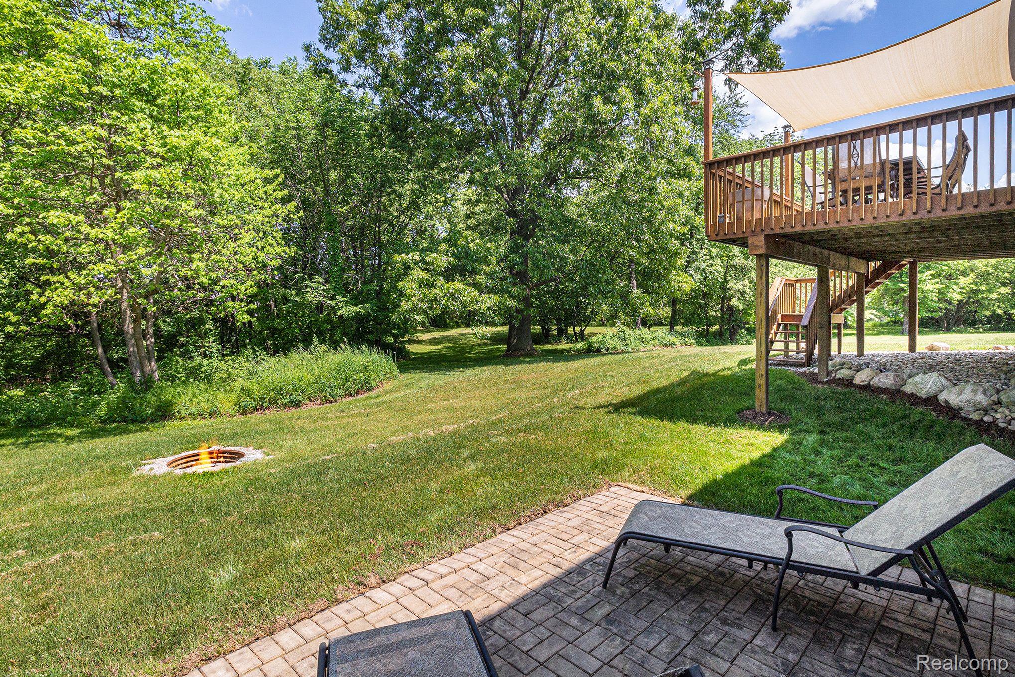 7611 East Highland Road Howell, MI 48855 - Photo 5 of 33 Walkout to Patio with firepit