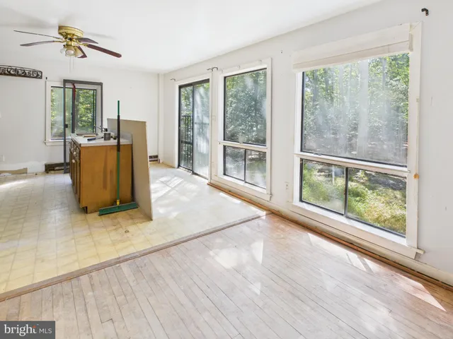 a view of a kitchen with a sink and refrigerator