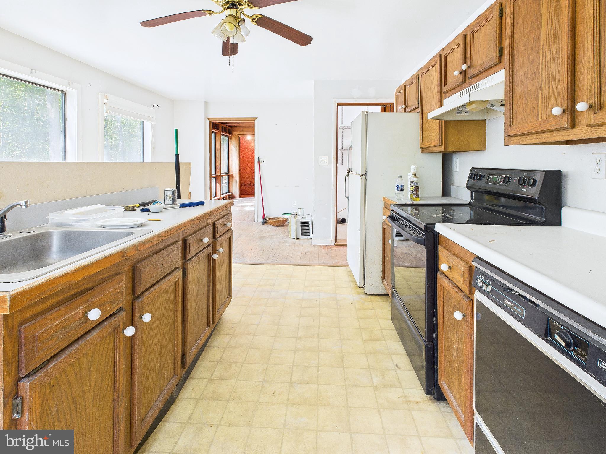 11330 Holly Springs Road Nanjemoy, MD 20662 - Photo 15 of 42 a kitchen with stainless steel appliances a sink stove and cabinets