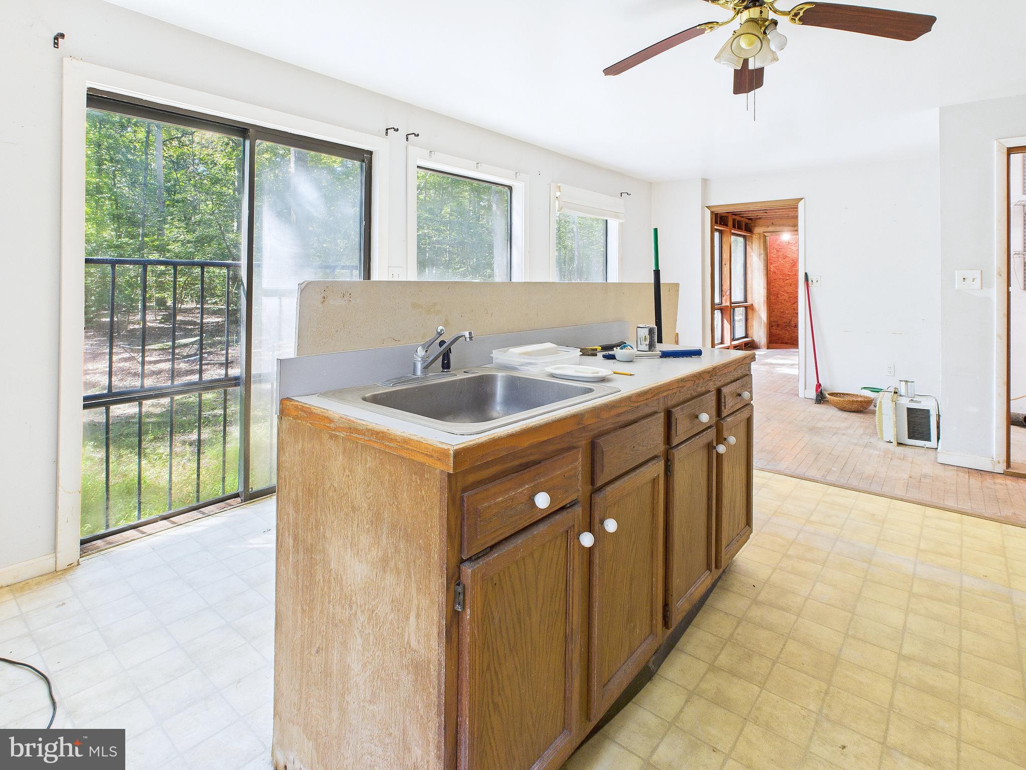11330 Holly Springs Road Nanjemoy, MD 20662 - Photo 16 of 42 a kitchen with a sink a counter top space and living room
