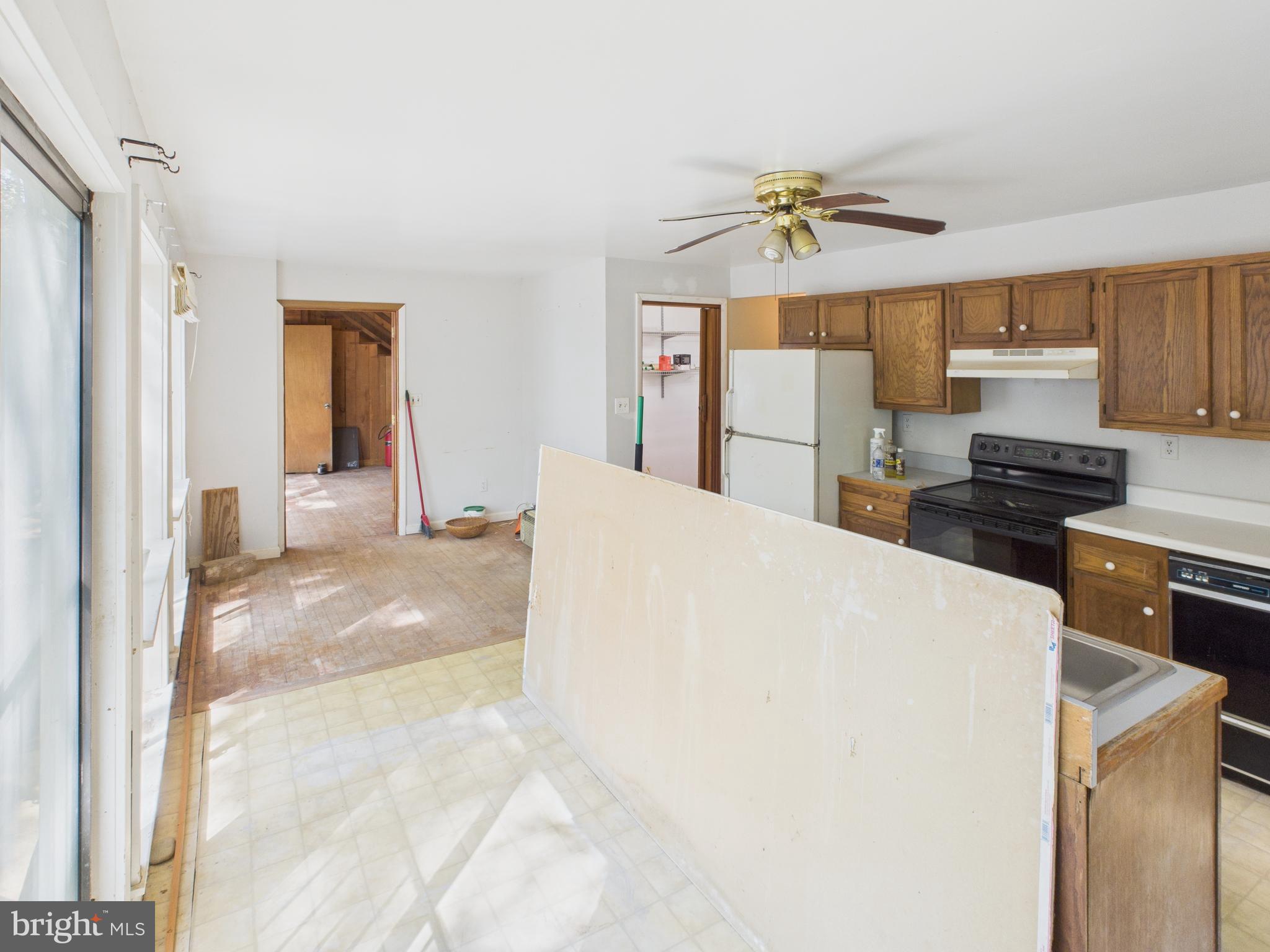 11330 Holly Springs Road Nanjemoy, MD 20662 - Photo 17 of 42 a living room with stainless steel appliances furniture a chandelier and a kitchen view