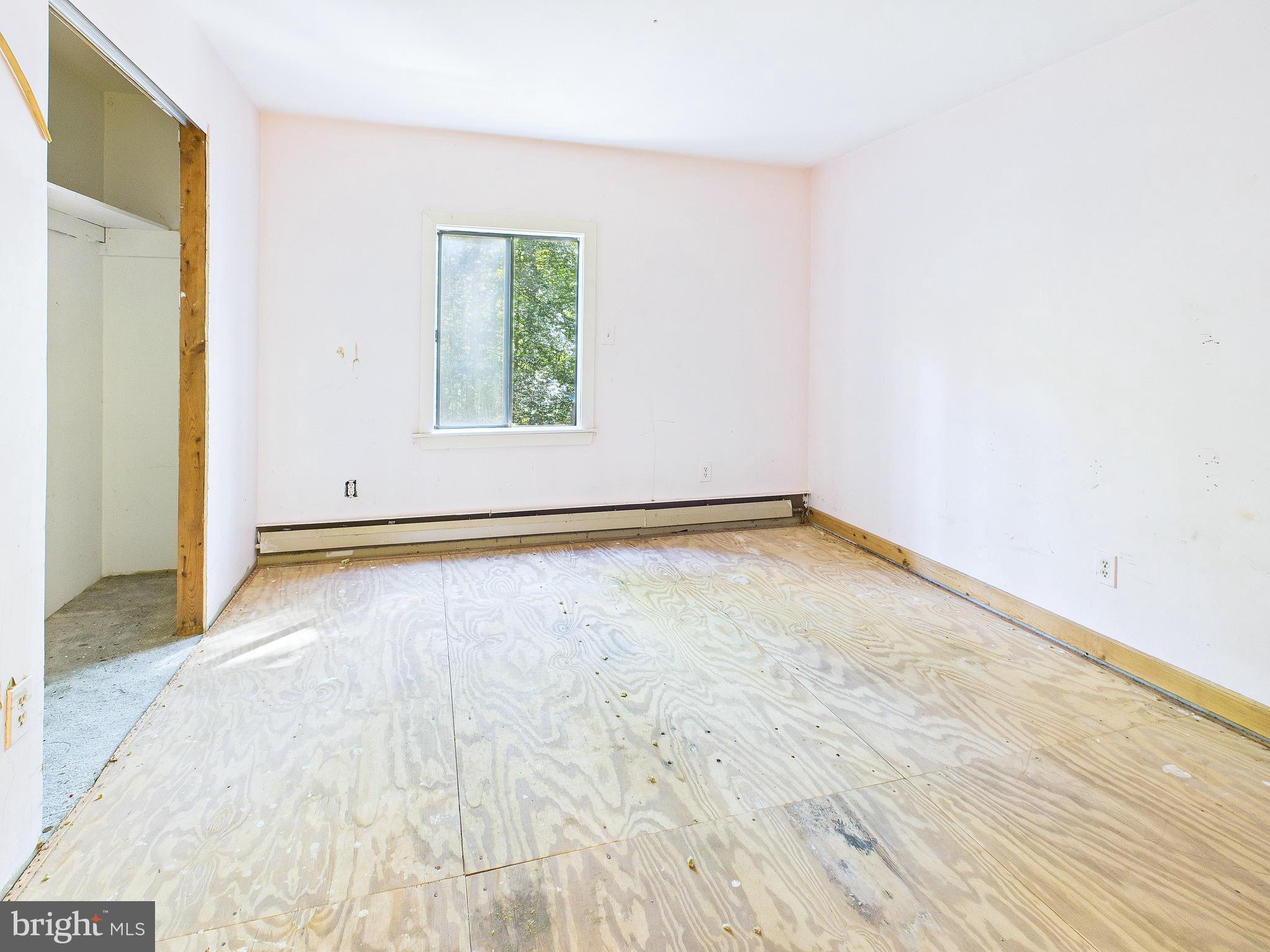 11330 Holly Springs Road Nanjemoy, MD 20662 - Photo 19 of 42 an empty room with wooden floor and windows