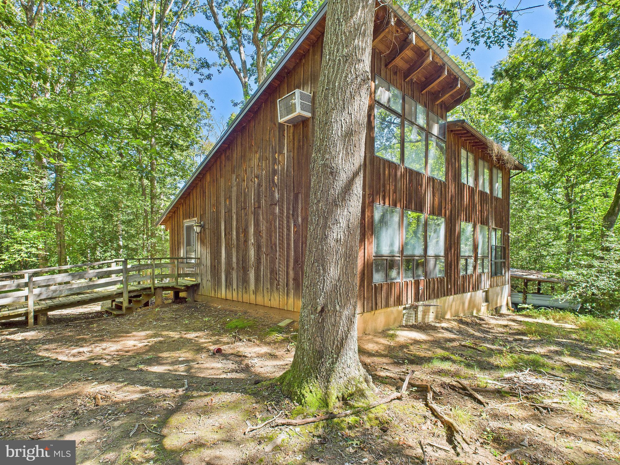 11330 Holly Springs Road Nanjemoy, MD 20662 - Photo 2 of 42 a backyard of a house with table and chairs and wooden fence