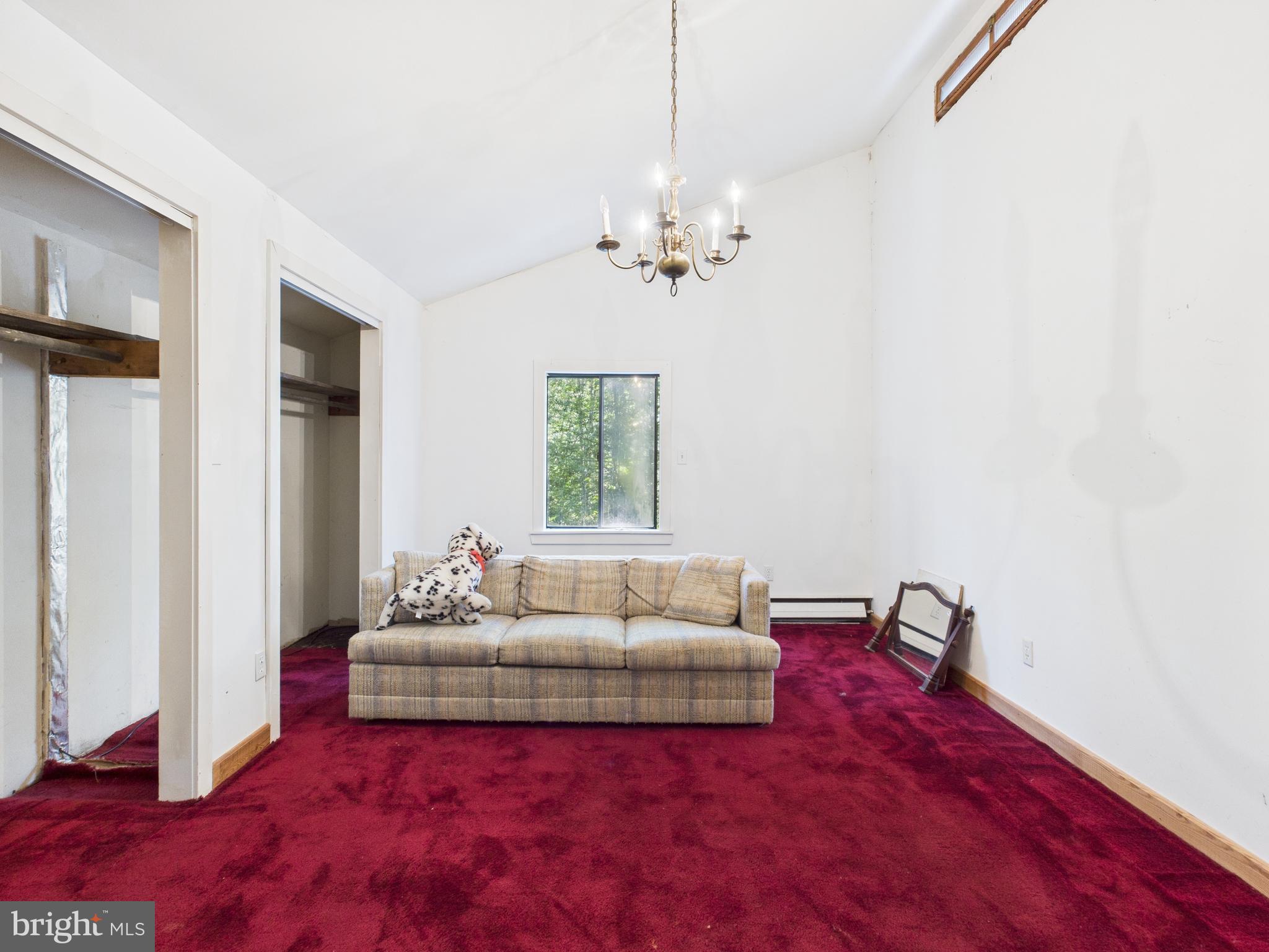 11330 Holly Springs Road Nanjemoy, MD 20662 - Photo 28 of 42 a living room with furniture and a chandelier