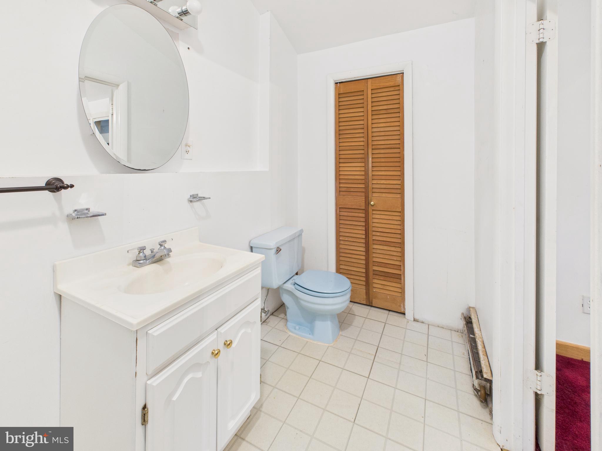 11330 Holly Springs Road Nanjemoy, MD 20662 - Photo 31 of 42 a bathroom with a sink a toilet and a mirror