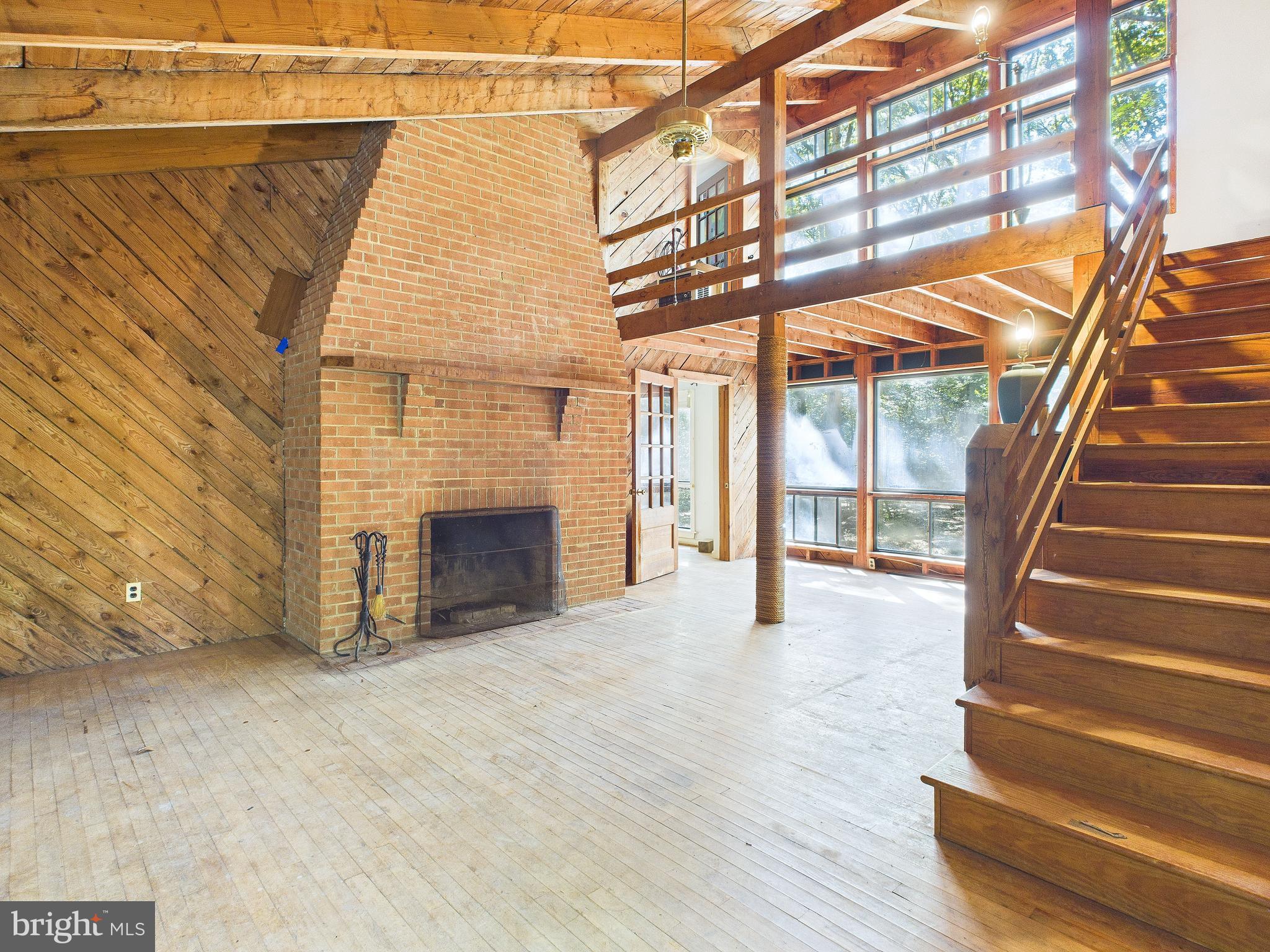 11330 Holly Springs Road Nanjemoy, MD 20662 - Photo 5 of 42 a view of an empty room with wooden floor and a fireplace