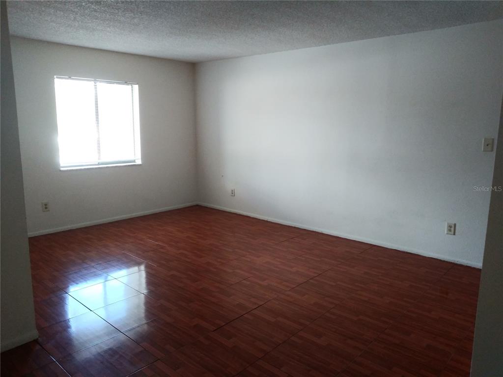 127 Springwood Circle, Unit H Longwood, FL 32750 - Photo 2 of 12 an empty room with wooden floor and windows