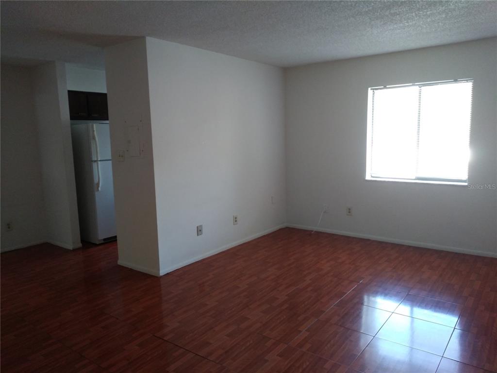 127 Springwood Circle, Unit H Longwood, FL 32750 - Photo 3 of 12 an empty room with wooden floor and windows