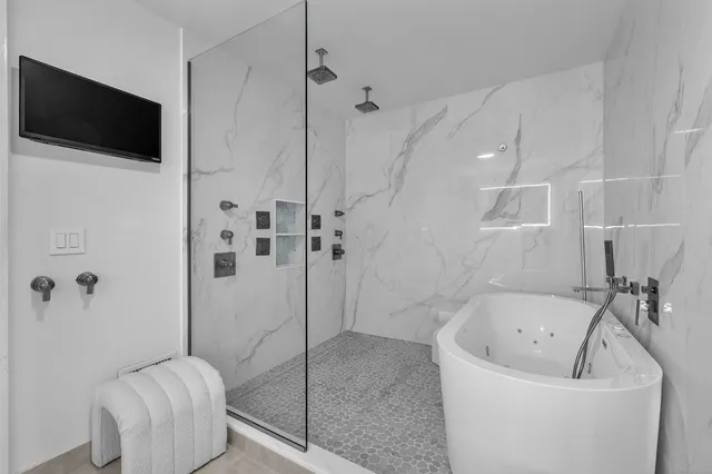 a bathroom with a tub and a shower
