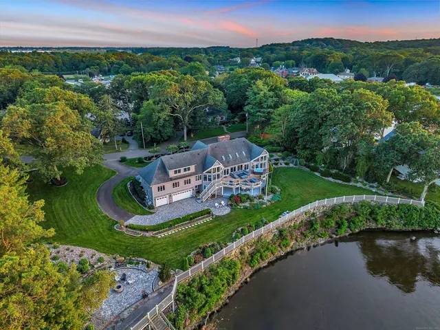 an aerial view of a house with a garden and lake view