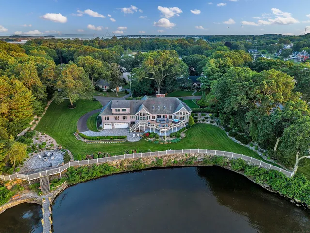 an aerial view of a house with a garden and outdoor seating
