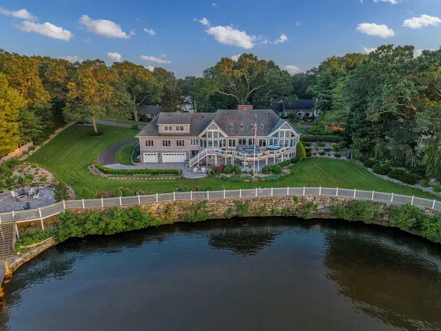 an aerial view of a house with a yard basket ball court and outdoor seating