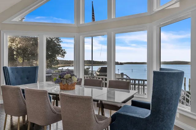 a living room with furniture and floor to ceiling windows