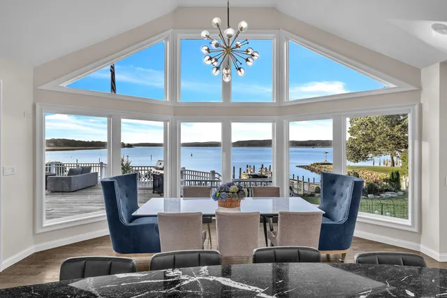 a living room with furniture and large windows