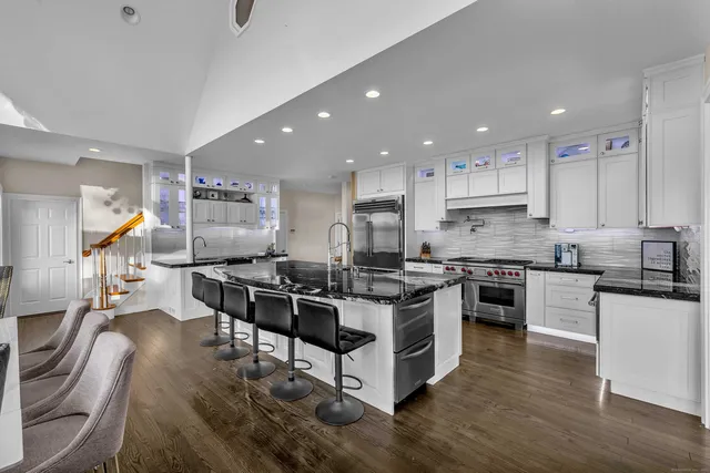 a kitchen with stainless steel appliances stove top oven and cabinets