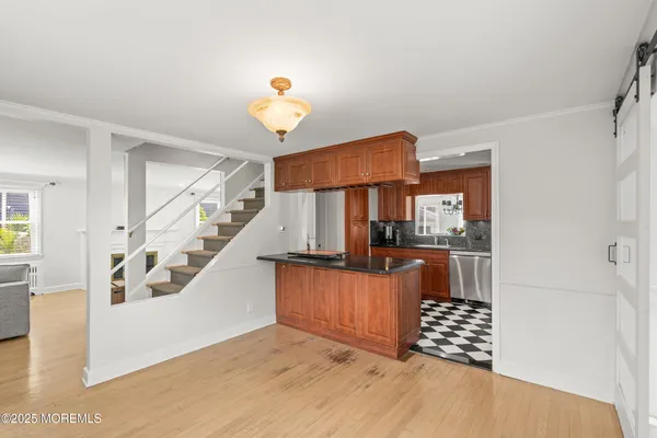 a view of kitchen with furniture and wooden floor