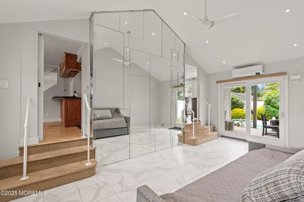 a living room with a large window and furniture