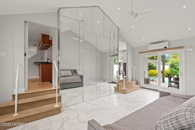 a living room with a large window and furniture