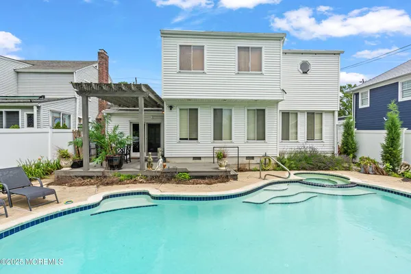 a view of swimming pool with seating space