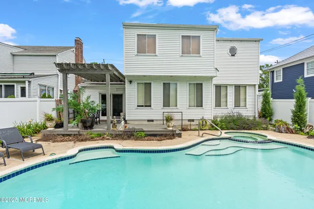 a view of swimming pool with seating space