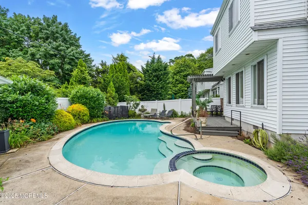 a view of a house with swimming pool and sitting area
