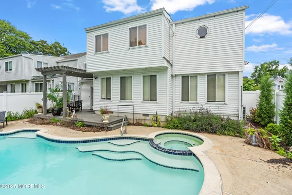 a front view of a house with a yard and a garden