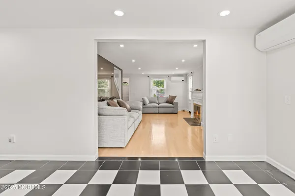 a living room with a black white checkered floor with a black white checkered floor