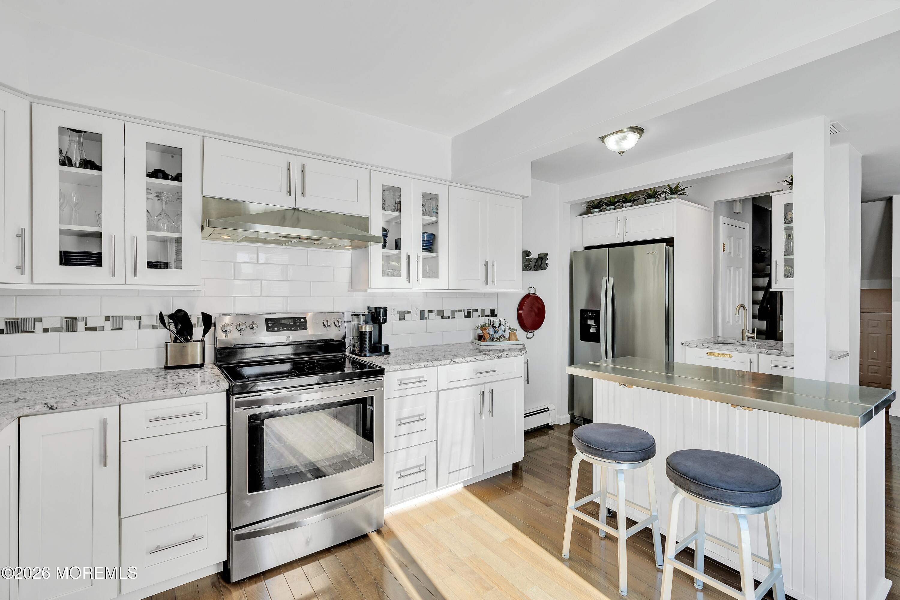 580 Patten Avenue, Unit 14 Long Branch, NJ 07740 - Photo 16 of 29 a kitchen with a stove and white cabinets