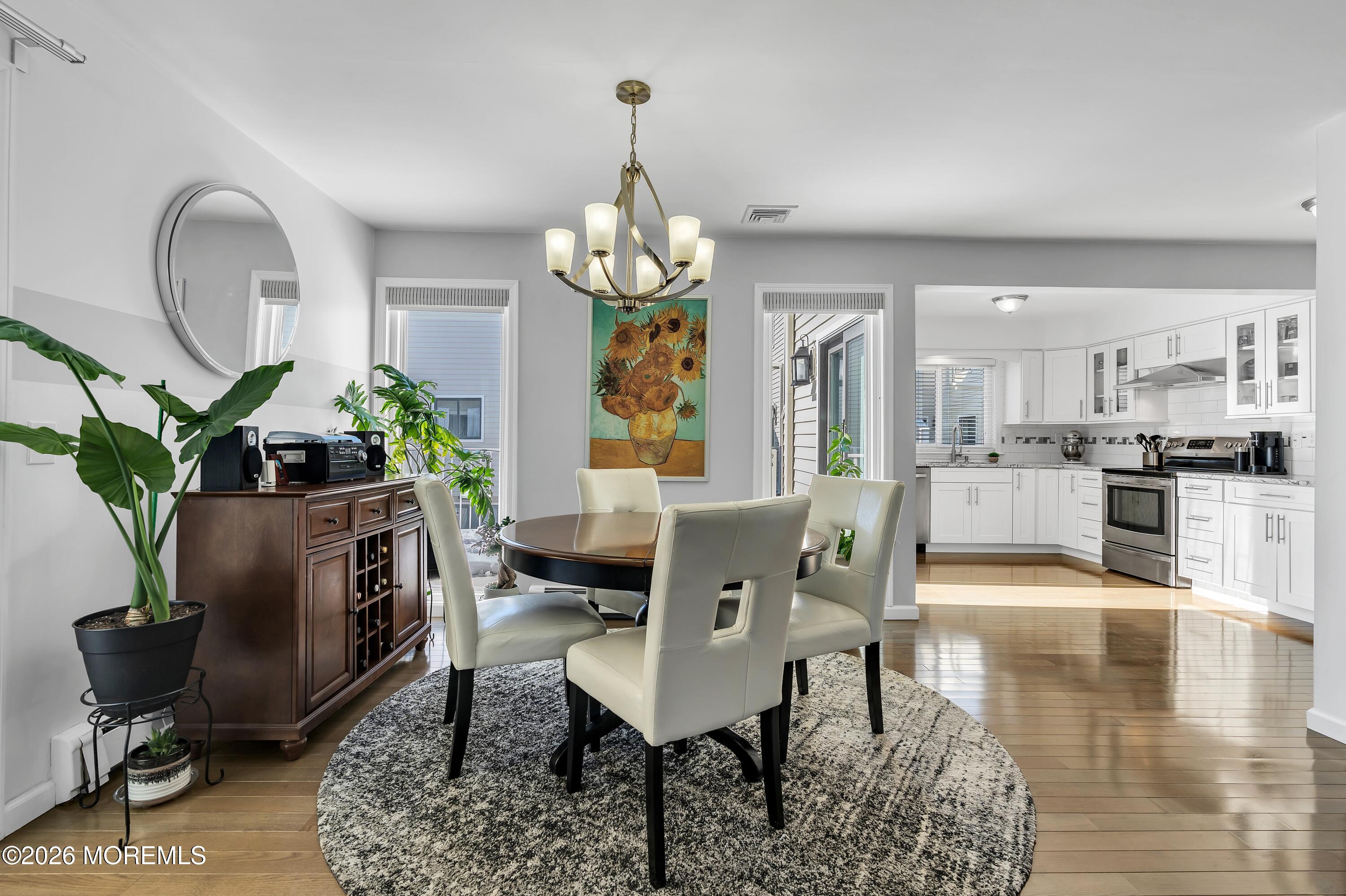 580 Patten Avenue, Unit 14 Long Branch, NJ 07740 - Photo 18 of 29 a view of a dining room and livingroom with furniture wooden floor a chandelier