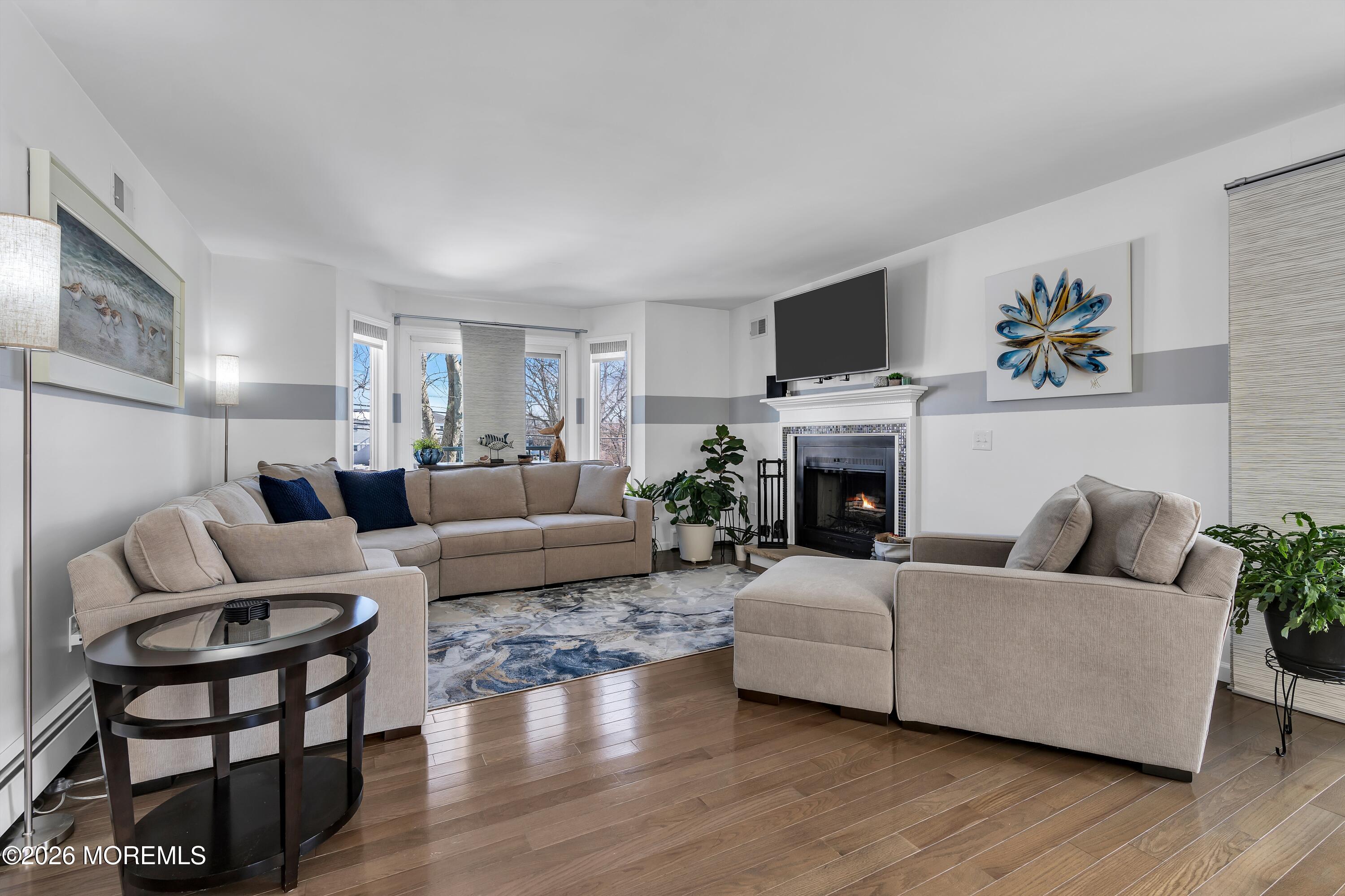 580 Patten Avenue, Unit 14 Long Branch, NJ 07740 - Photo 20 of 29 a living room with furniture a flat screen tv and a fireplace