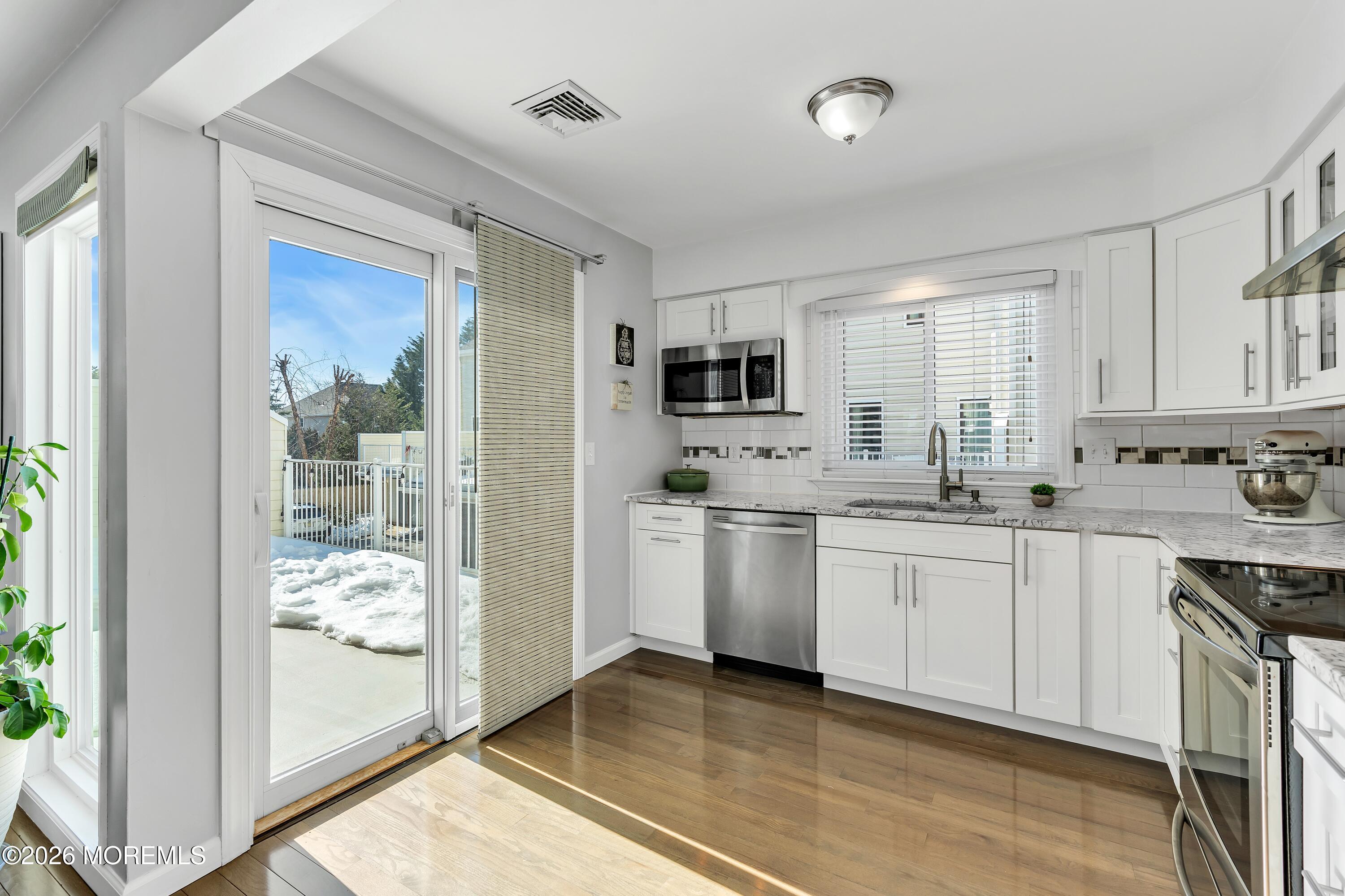 580 Patten Avenue, Unit 14 Long Branch, NJ 07740 - Photo 4 of 29 a kitchen with white cabinets and appliances